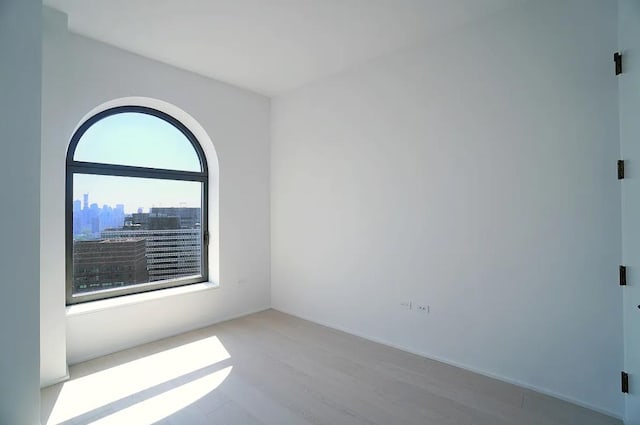 130 William St Unit 33C, New York City, NY 10038 - spare room featuring wood finished floors and a view of skyline