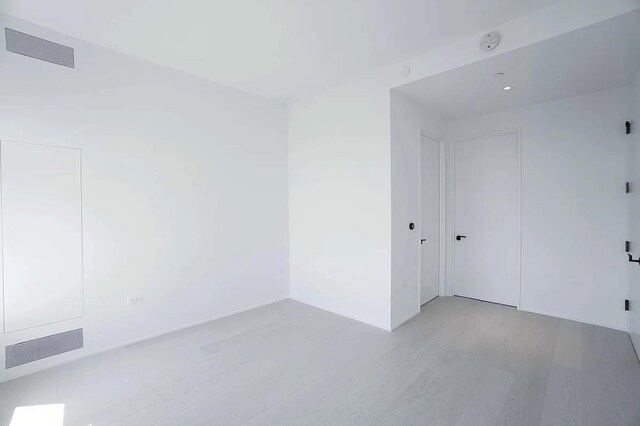 spare room with light hardwood / wood-style floors