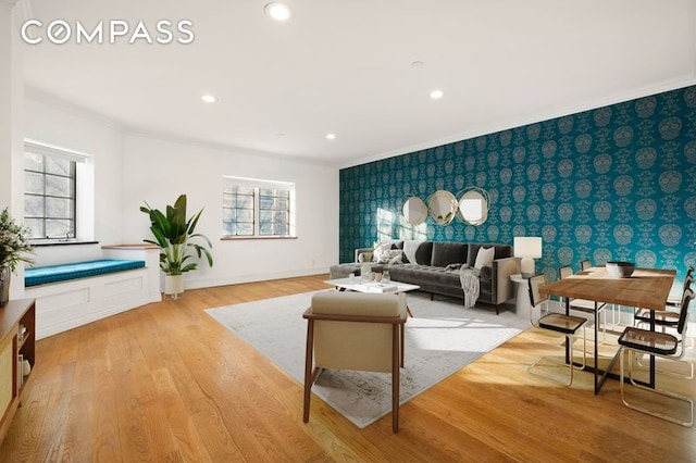 living room featuring ornamental molding and light hardwood / wood-style floors