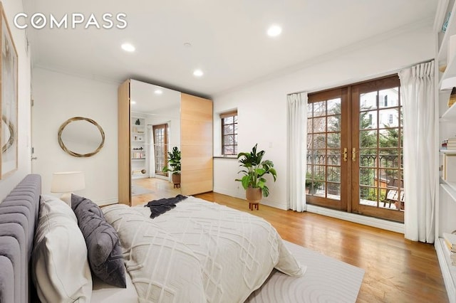 bedroom with crown molding, recessed lighting, access to outside, french doors, and light wood-style flooring
