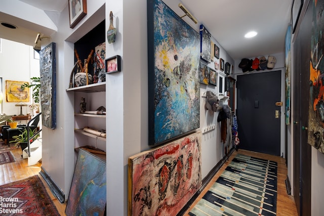 hallway with hardwood / wood-style flooring