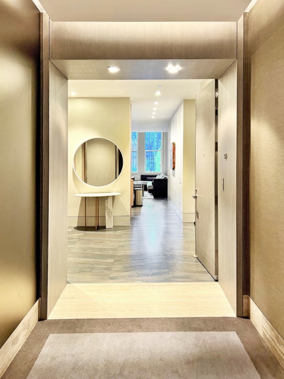 corridor with light wood-type flooring