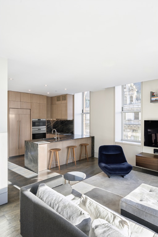 living room with sink and wood-type flooring