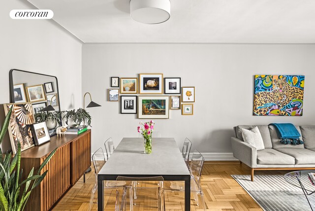 dining space with parquet flooring