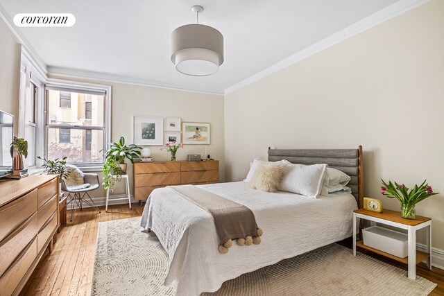 bedroom with crown molding and wood-type flooring