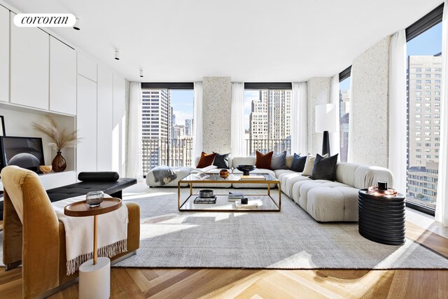 living room with floor to ceiling windows and light hardwood / wood-style floors