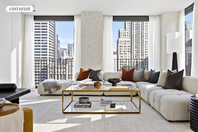 living room with floor to ceiling windows and a healthy amount of sunlight