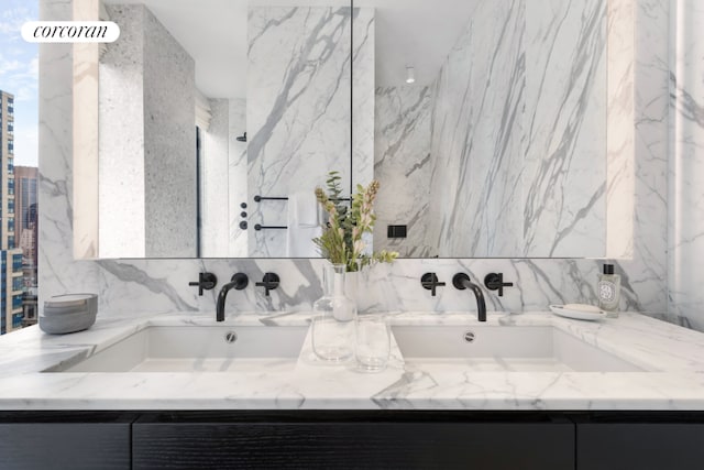 bathroom with vanity and tile walls