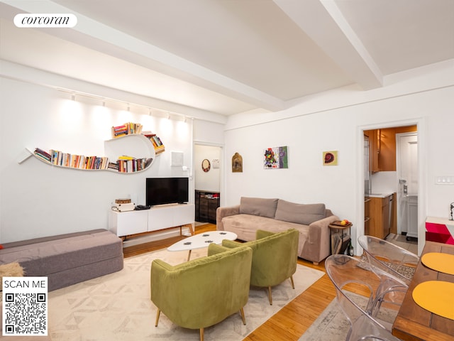 living room with beamed ceiling, wood finished floors, and visible vents