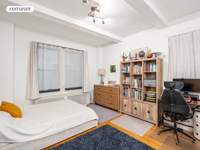 living room featuring hardwood / wood-style floors and beam ceiling