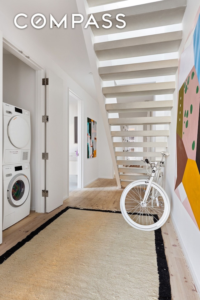 interior space featuring stacked washer / dryer and wood finished floors