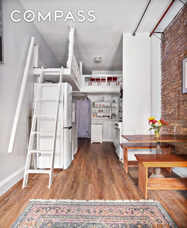 interior space with dark hardwood / wood-style flooring, fridge, and white cabinets