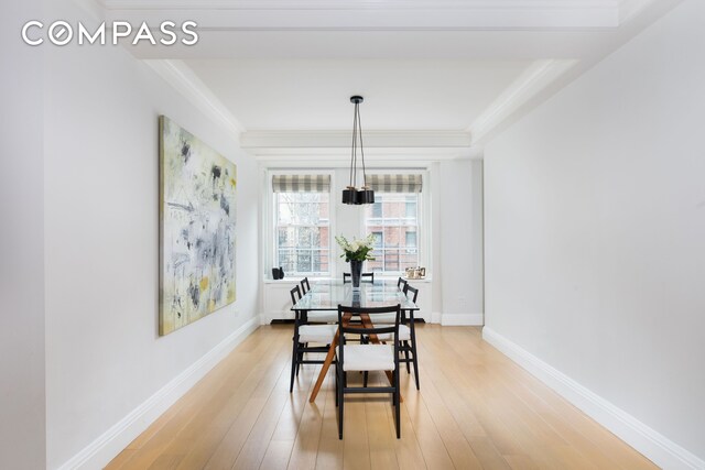 dining space featuring hardwood / wood-style flooring and ornamental molding