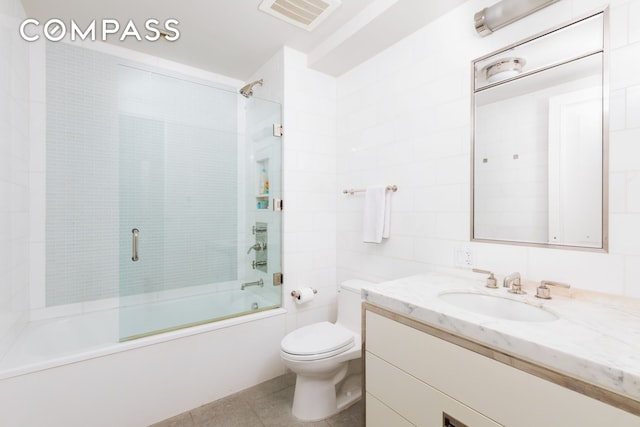 bathroom with vanity, visible vents, enclosed tub / shower combo, tile patterned flooring, and toilet