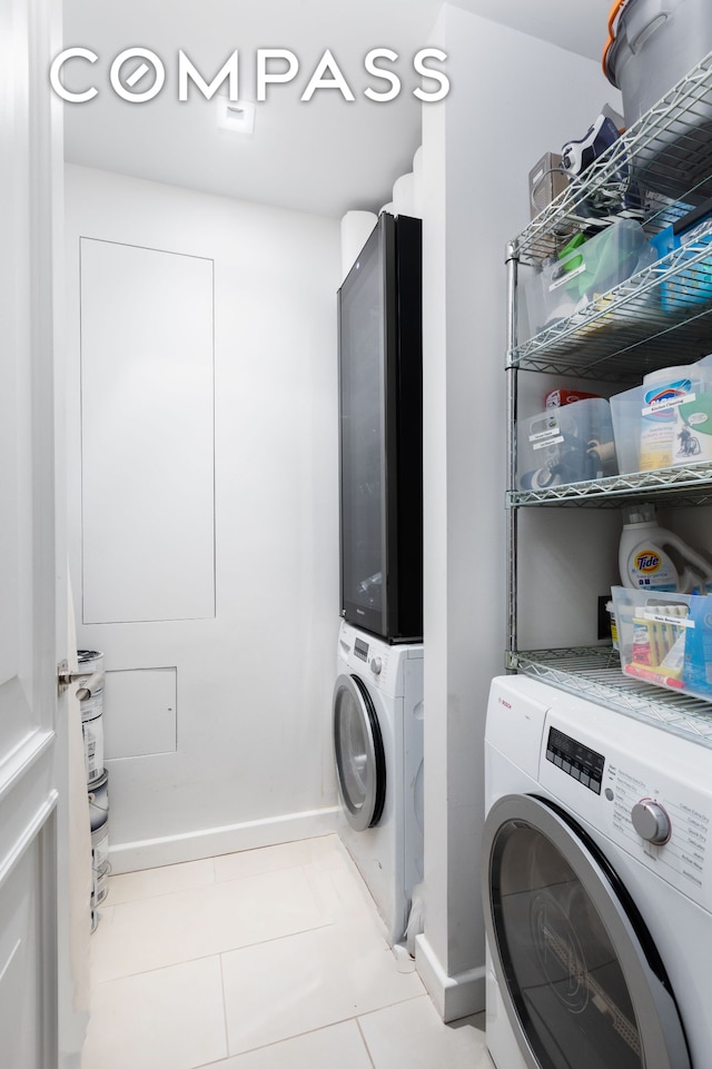 washroom featuring washer / dryer, laundry area, and tile patterned flooring