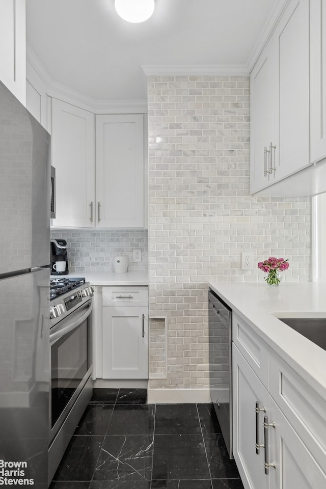 kitchen featuring tasteful backsplash, white cabinets, stainless steel appliances, and light countertops