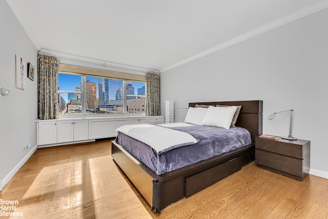 bedroom with ornamental molding, a view of city, light wood-style flooring, and baseboards