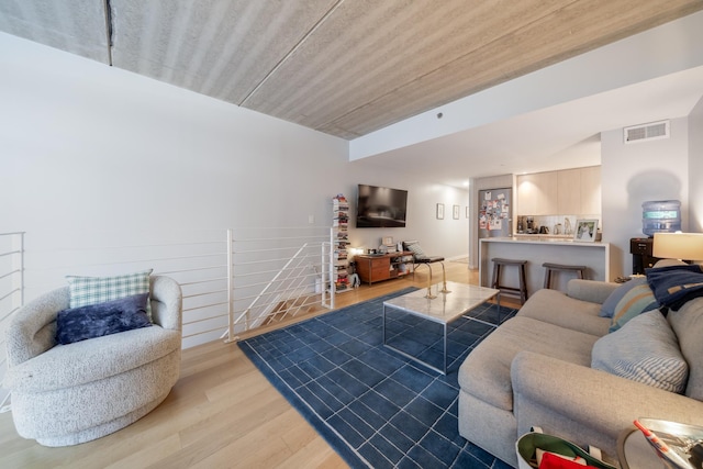 living area with light wood finished floors and visible vents