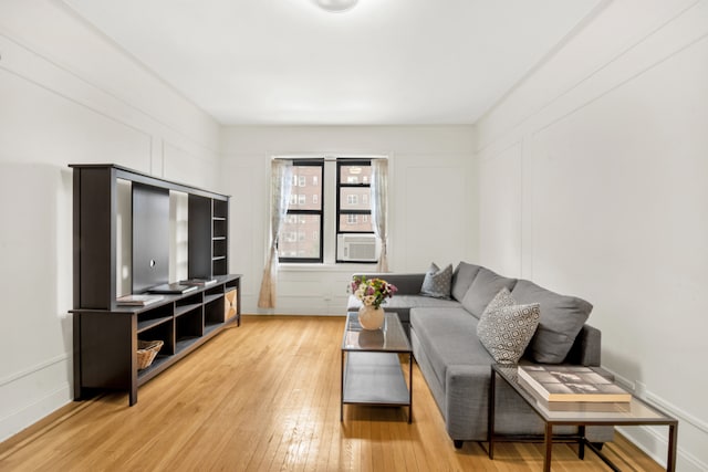 living room featuring cooling unit and light hardwood / wood-style floors