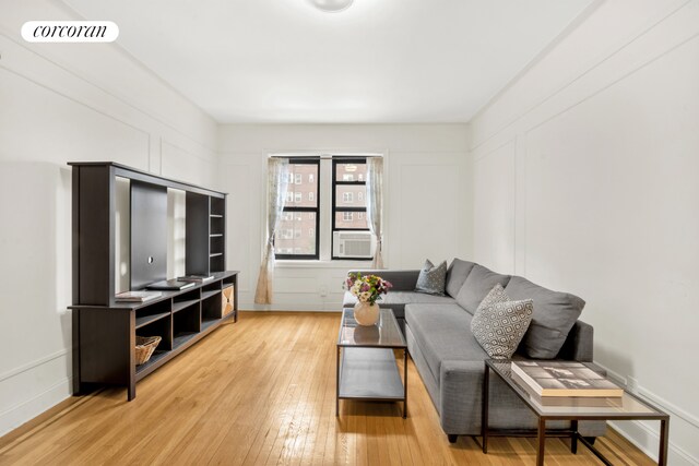 living room with cooling unit and light wood-type flooring