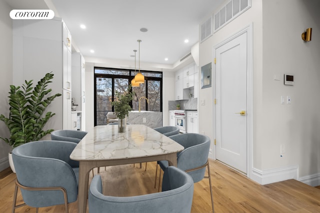 dining space with light hardwood / wood-style floors