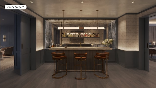 bar with hardwood / wood-style flooring and decorative light fixtures