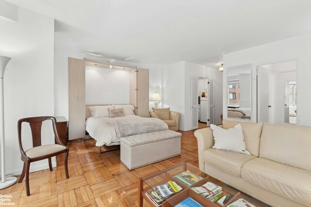 bedroom with light parquet flooring