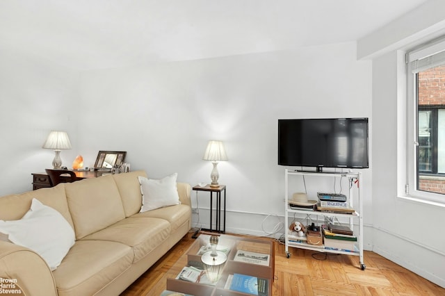 living room featuring a healthy amount of sunlight and baseboards