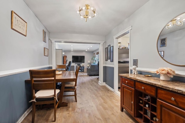 dining area featuring a chandelier and light wood-type flooring