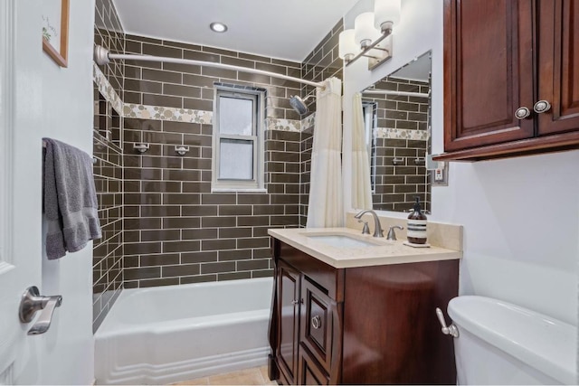 full bathroom featuring vanity, shower / bath combination with curtain, and toilet