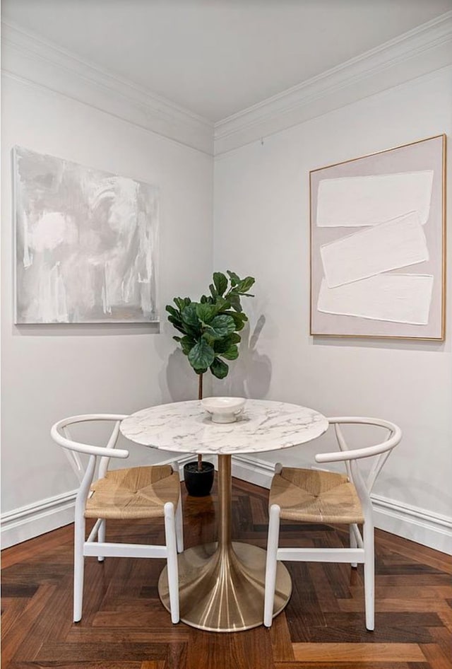 dining space featuring ornamental molding, breakfast area, and baseboards