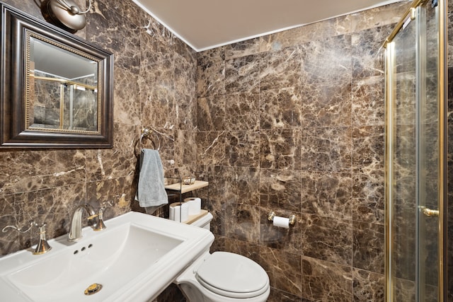 full bathroom with toilet, a stall shower, a sink, and tile walls