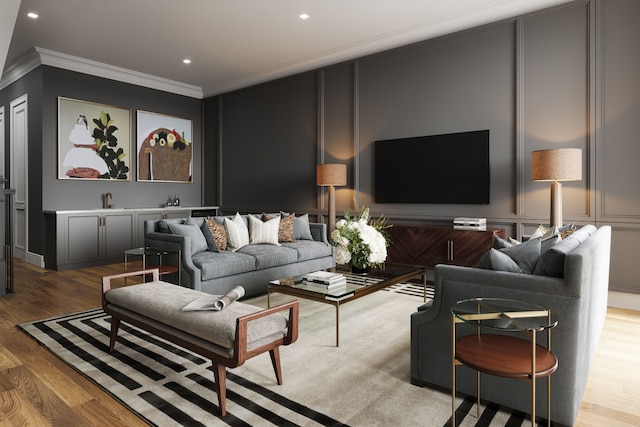 living room with recessed lighting, a decorative wall, crown molding, and wood finished floors