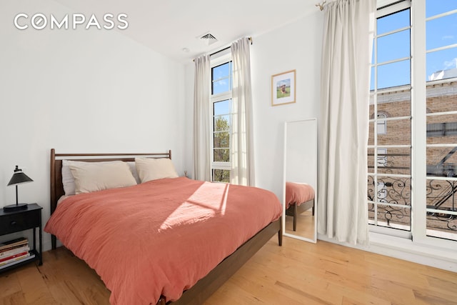 bedroom featuring visible vents and light wood-style floors