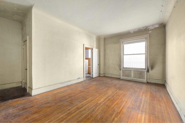 empty room with washer / clothes dryer and dark wood-type flooring