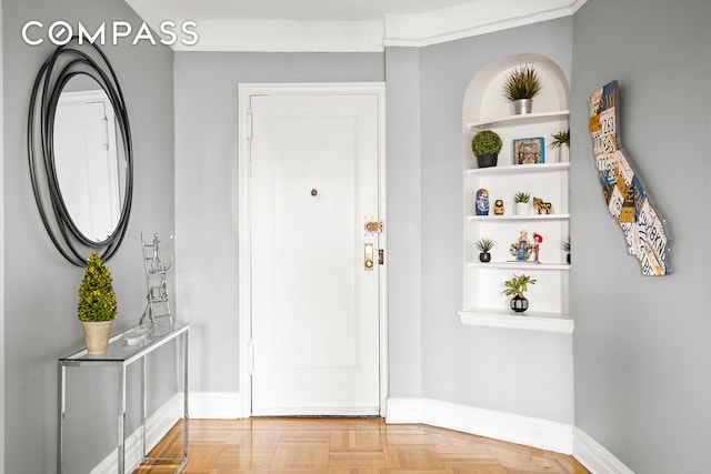 foyer featuring baseboards