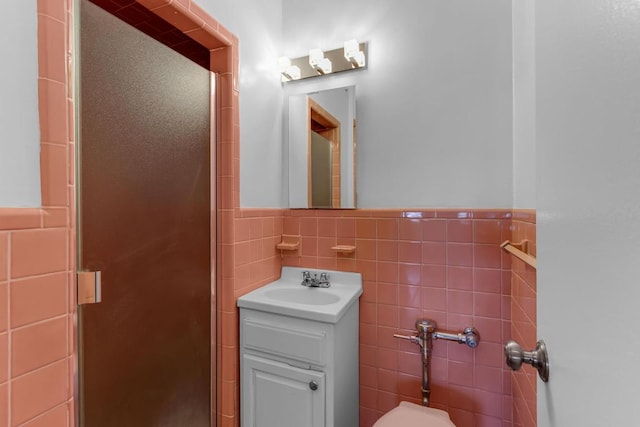 bathroom featuring tile walls, vanity, and walk in shower