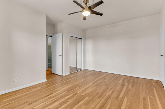 unfurnished bedroom with light hardwood / wood-style floors, a closet, and ceiling fan