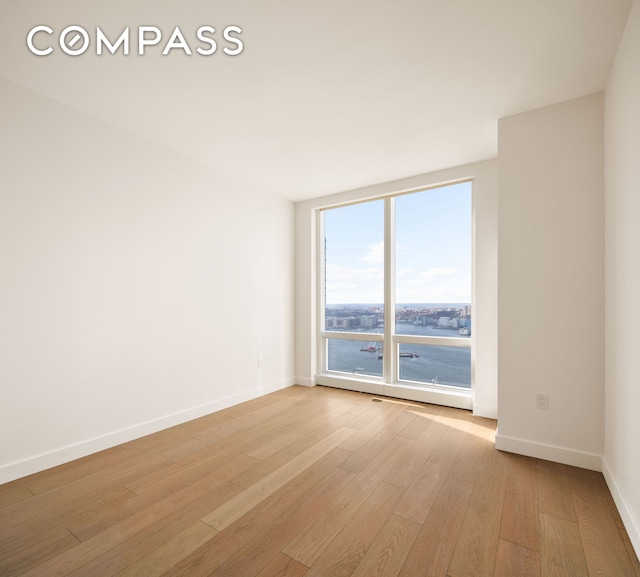 15 Hudson Yards Unit 37F, New York City, NY 10001 - empty room featuring baseboards and light wood-style floors
