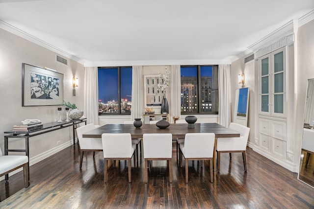 dining space with baseboards, visible vents, wood finished floors, and ornamental molding