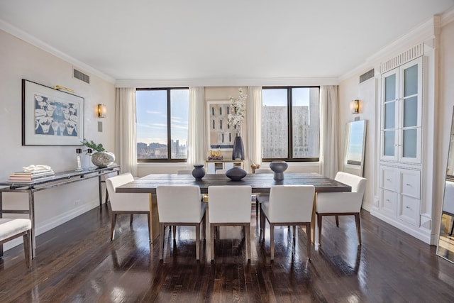 dining room featuring dark wood-style floors, visible vents, and ornamental molding