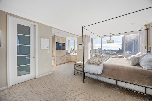 bedroom featuring light carpet, crown molding, and baseboards