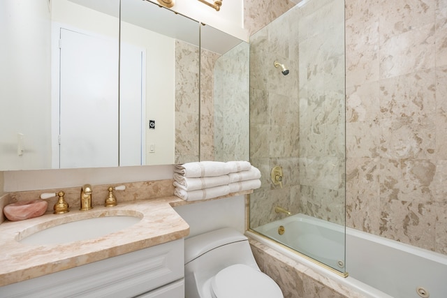 bathroom with tiled shower / bath combo, vanity, and toilet