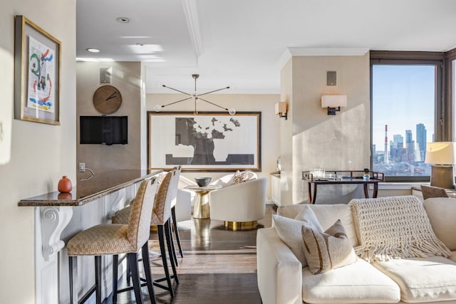 living room featuring a notable chandelier, crown molding, and dark hardwood / wood-style floors