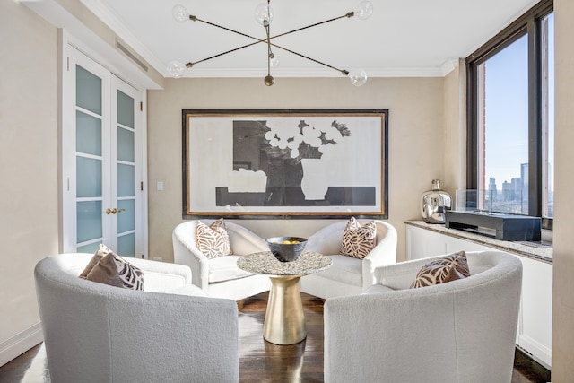 living area with ornamental molding, a view of city, dark wood-style flooring, and baseboards