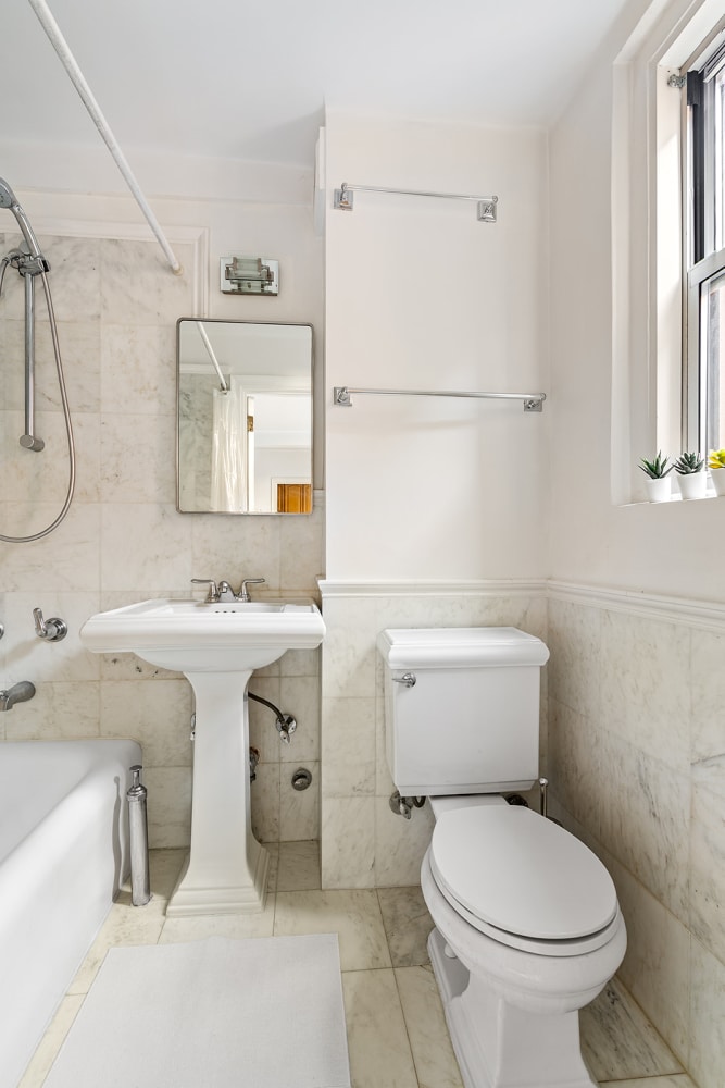 full bathroom featuring  shower combination, tile patterned floors, toilet, and tile walls