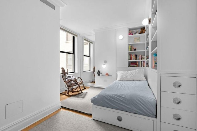 bedroom featuring wood finished floors and baseboards