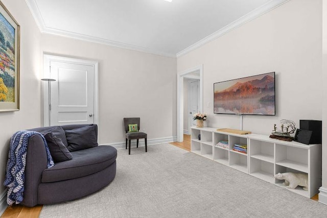 living area featuring carpet flooring, crown molding, and baseboards