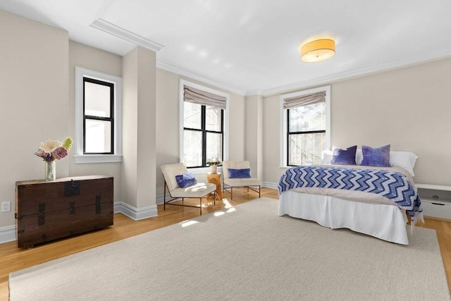 bedroom with wood finished floors and baseboards