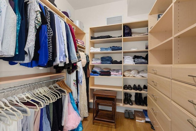 walk in closet with wood finished floors and visible vents